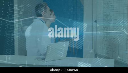Scanning data, two medics in lab coats using laptop and board in lab, with digital overlay Stock Photo