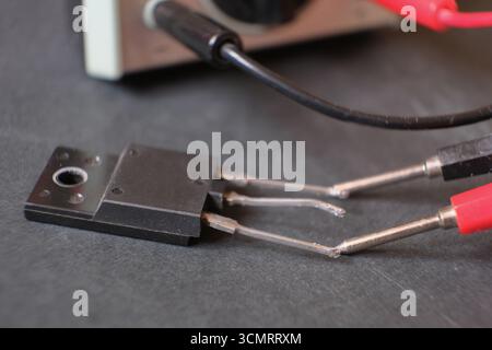 Transistor. A power transistor testing with the multimeter Stock Photo