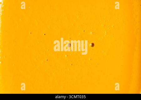 Closeup yellow background with texture of watercolor paints. Macro Stock Photo