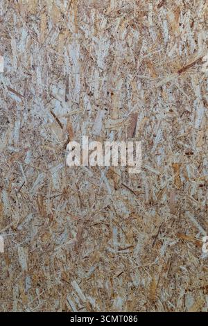 Close-up view of oriented strand board (OSB) texture, showcasing the intricate pattern of wood strands and flakes, commonly used in construction and D Stock Photo