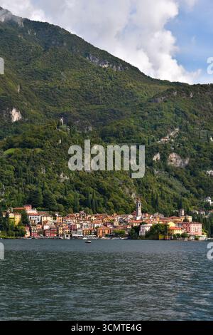 The Lomardy town of Varenna, situated on the eastern bank of Lake Como in Italy, with a backdrop of forested mountainside. Stock Photo