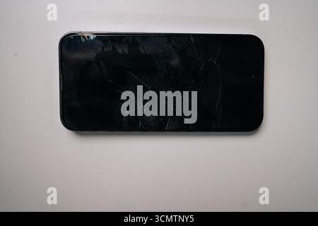 Top view of broken screen protector glass on smartphone, highlighting damage and cracks, emphasizing importance of screen protection, nobody. Stock Photo
