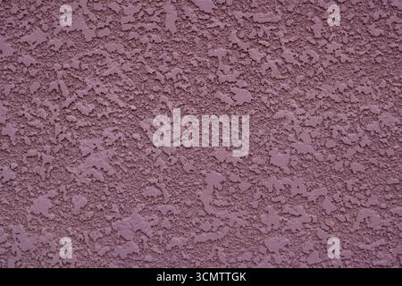Closeup of plastered exterior wall of mauve color. Textured background. Stock Photo