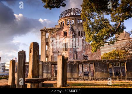 Historic Hiroshima Peace Memorial Dome at Sunset with Golden Light and Trees in Hiroshima Peace Memorial Park, Japan Stock Photo