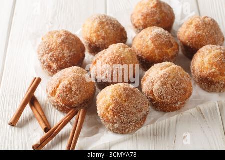 Close-up of sweet cinnamon muffin donuts baked, not fried, on a wooden table. Horizontal Stock Photo