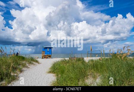 Path to Venice Beach on the Gulf of America, formerly the Gulf of Mexico, with rain storm clouds over the water in Venice Florida USA Stock Photo
