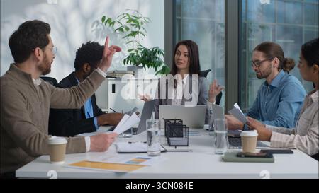 Multicultural Caucasian Indian group businesswomen businessmen women men business teamwork office coworkers females males discuss project together Stock Photo