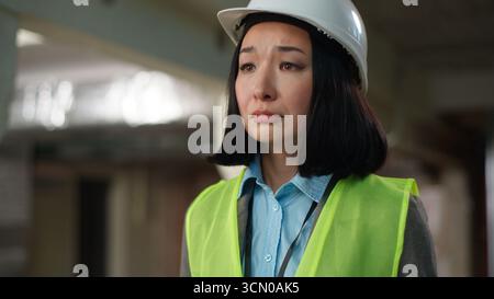 Nervous Asian Korean Japanese woman builder checking documents problem mistake building plan project businesswoman Chinese contractor business female Stock Photo