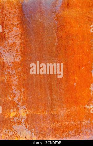 Close-up of a rusted metal surface showing a range of textures, from smoother areas to more pitted and uneven sections. The color varies between deep Stock Photo