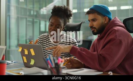 Multi-Ethnic entrepreneurs of informal business startup in office meeting diverse team work process in company workgroup, African American woman talk Stock Photo