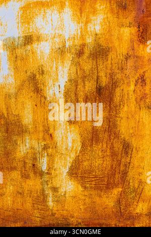 Extensive rust on a scratched metal surface with vertical white paint leftovers and dark corrosion spots Stock Photo