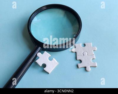The Magnifying Glass and a Puzzle Stock Photo