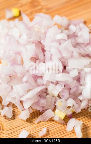 Organic Raw Cut Diced Shallot Onion on a Cutting Board Stock Photo