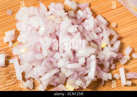 Organic Raw Cut Diced Shallot Onion on a Cutting Board Stock Photo