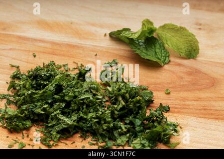 Chopped Mint Leaves on Wooden Cutting Board Stock Photo