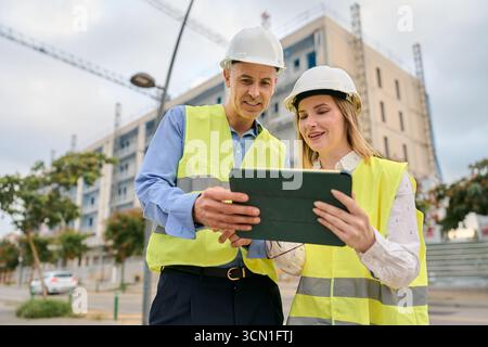 Engineers planning construction project using digital tablet Stock Photo