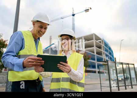 Construction engineers working together using digital tablet Stock Photo