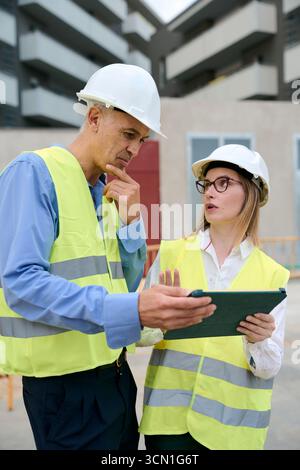 Construction engineers planning project using digital tablet Stock Photo