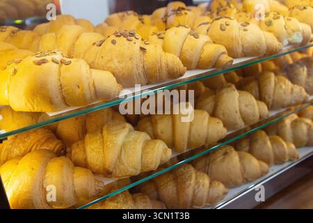 Fresh delicious croissants on display in the bakery. Food Stock Photo