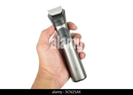 electric hair trimmer in hand isolated on white background with clipping path Stock Photo