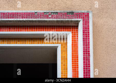 Colorful geometric mosaic tiles on an old building facade Stock Photo