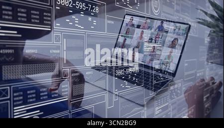 Displaying laptop screen showing team grid, data overlays on desk, hands hovering, plant beside. Technology, collaboration, digital, workspace, commun Stock Photo