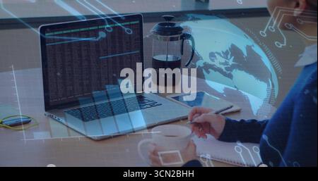 Stirring mug female coder in sweater writing code notes at workspace, with laptop, copy space. Technology, digital, workspace, productivity, modern, i Stock Photo