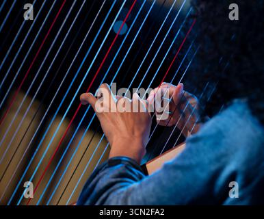 Hand playing on harp Stock Photo