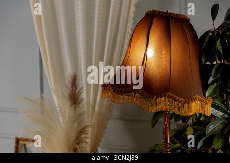 This Vintage Style Table Lamp emits a Warm Glow, ideal for enhancing any Elegant Interior Stock Photo