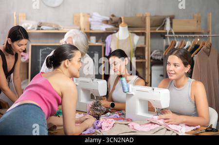Multigenerational group of women enjoying sewing class in workshop Stock Photo