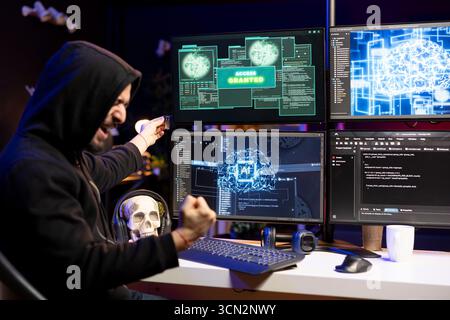 Ecstatic hacker doing covert operations celebrating after bypassing security using USB virus. Rogue programmer overjoyed after successfully penetrating firewalls, getting access granted message Stock Photo