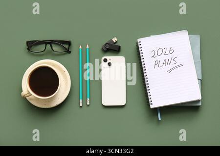 Notebook with text GOALS 2026, mobile phone and cup of coffee on green background Stock Photo