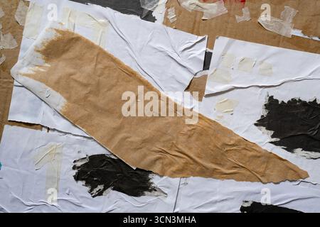 Random shape torn paper glued onto a cardboard texture Stock Photo