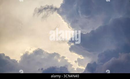 Blue sky with clouds, thunderclouds, summer weather. Sunset. White clouds. Rain. Stock Photo