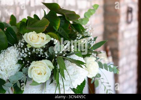Stunning floral arrangement featuring white roses, hydrangeas, and lush greenery, perfect for weddings or special events Stock Photo