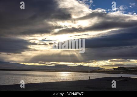 Shines through the clouds over pyramid Lake Nevada Stock Photo