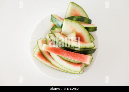 Sliced watermelon on white plate, refreshing summer treat Stock Photo