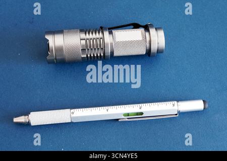 Products from aluminum, a flashlight and a writing pen. Stock Photo