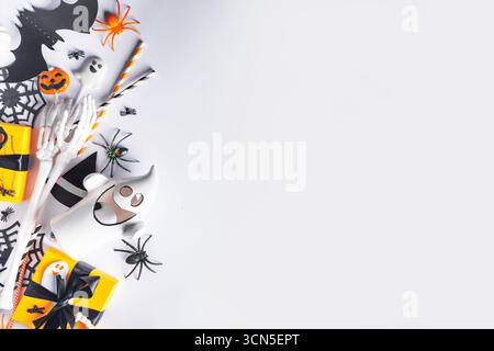 Happy Halloween holiday greeting card background. Flat lay gift boxes, set of Halloween symbols- spiders, bats, pumpkin, party decorations on white ba Stock Photo