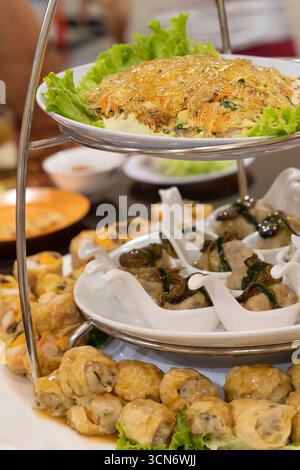 Elegant presentation of assorted asian delicacies on a multi-tier plate stand Stock Photo