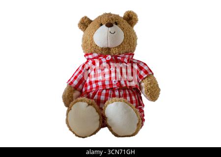 soft Teddy bear wearing red and white gingham outfit isolated on white background Stock Photo