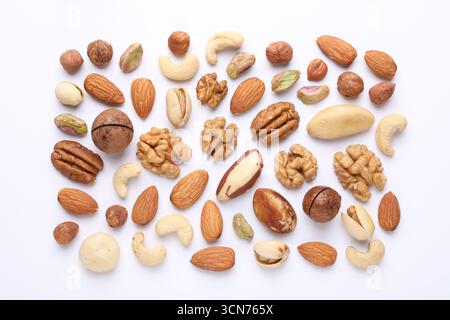 Mix of different nuts on white background, flat lay Stock Photo