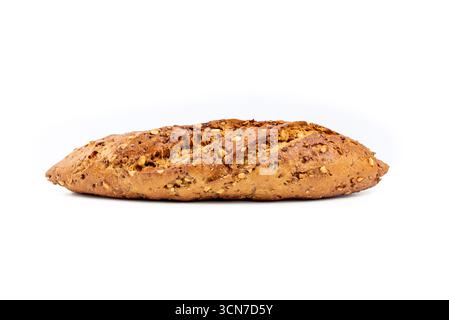 A long, thin loaf of bread with nuts on top. The bread is brown and has a nutty flavor Stock Photo