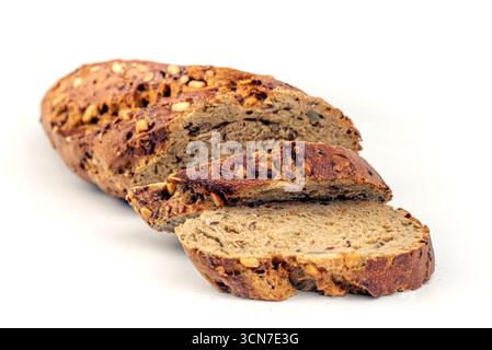 A slice of bread with nuts on it. The bread is cut in half Stock Photo
