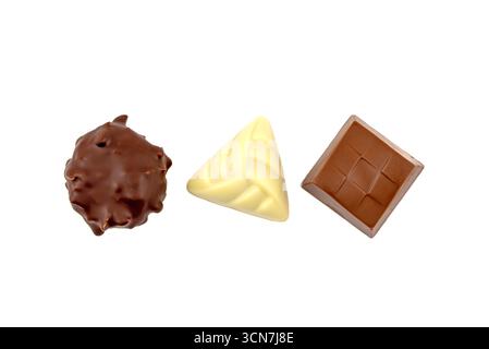 Three different shaped chocolates are shown on a white background. The first chocolate is a square, the second is a triangle, and the third is a diamo Stock Photo