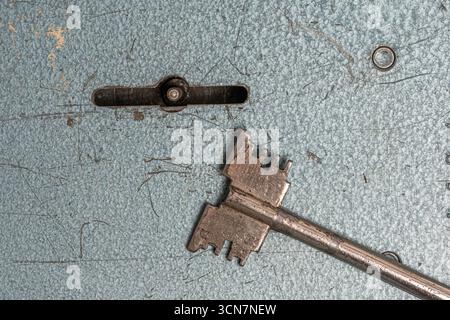 Old rusty key on background old wall. Concept security Stock Photo