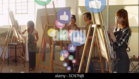 Painting artists wearing aprons mixing colors on canvases in art studio, with easels and like icons Stock Photo