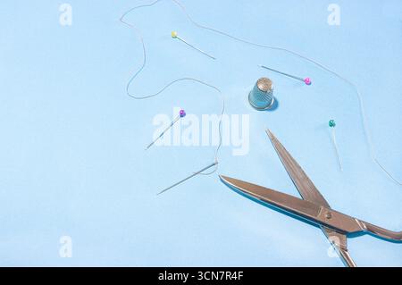 Sewing needles, thread, scissors, and thimbles. Stock Photo