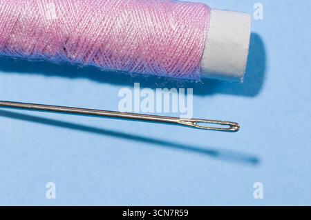 Sewing needles, thread, scissors, and thimbles. Stock Photo