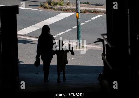 Underpass, passers-by, dark, mother and child, symbolic image, Stock Photo